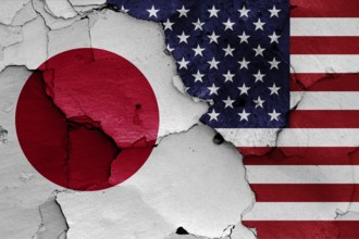 Flags of Japan and USA painted on cracked wall
