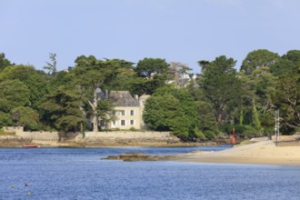 Coast of Combrit, district Le Moguer with historic villa by the sea, seen from Benodet, department
