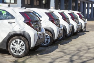 White small cars parked in a row, rear view, Germany