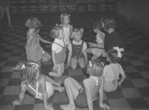 Children in the 1930s. A group of small girls at a dancing school playing together. Photo