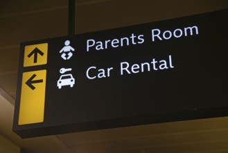 Airport signage for the parents room and car rental at Wellington, New Zealand