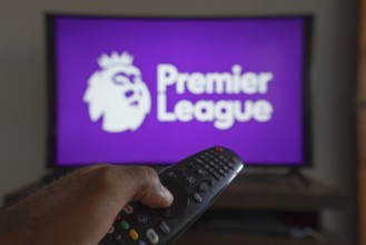 May 14, 2024, Brazil. In this photo illustration, a hand holding a TV remote control in front of