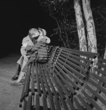 In the 1950s. A young couple is sitting on a bench kissing. A date ending pretty well. Sweden 1953