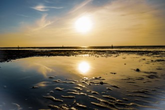 Sunset with clear reflection in the calm water on a sandy beach, North Sea beach 27476