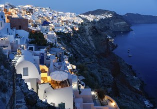 Blue hour after sunset, view from Oia to white buildings on the crater rim, Santorini, Cyclades,