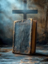 A dusty old book stands upright illuminated by ambient light with a cross in a mysterious, misty