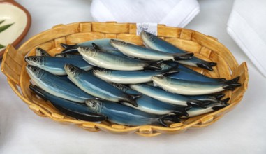 Bowl of pottery ceramic fish sardines in gift shop, city of Guimaraes, northern Portugal