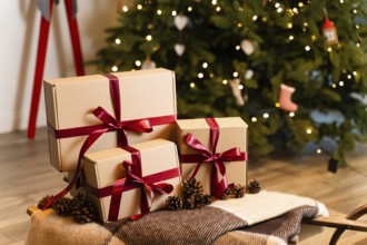 Groups of Christmas presents with craft papers on the sledges against the backdrop of a Christmas