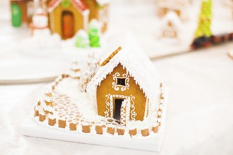 Gingerbread cookie house in the Christmas village on the fair. Holiday traditional aroma dessert