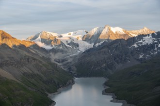 View at the summit of Mont de la Blana, alpenglow at sunset, view of a blue mountain lake, Lac des