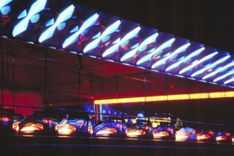 Illuminated bumper cars at night, New Jersey, USA