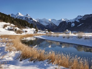 River Sihl flows into Lake Sihl, reservoir, behind the snow-covered mountains Flübrig and