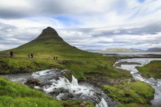 Kirkjufell mountain, film set, hikers, tourists at Kirkjufellfoss waterfall, Kirkjufellsa river,