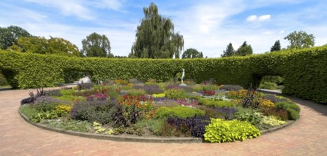Lindenrund flower roundabout in Grugapark Essen, containing a bronze sculpture of a female javelin
