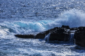 Rugged rocky coastline and foaming spray, on Stecci beach, near Capoliveri, Elba Island, Tuscan