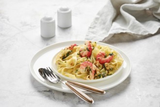 A plate of fettuccine allo scoglio showcases a mix of seafood, including shrimp and mussels,