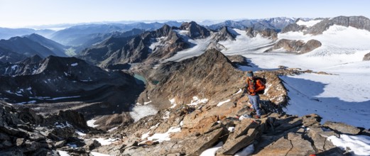 Mountaineer on a rocky ridge on the Wilder Freiger summit, behind him Signal summit and Becher