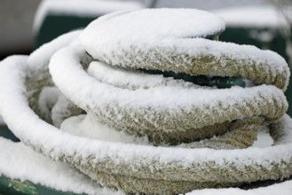 Thick ship rope covered with snow, close-up, North Sea, Norddeich, Lower Saxony, Germany