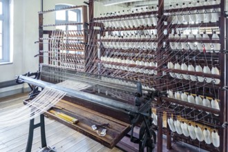 Bramsche, Lower Saxony, Germany, weaving machine, loom, in a textile factory, numerous spools of