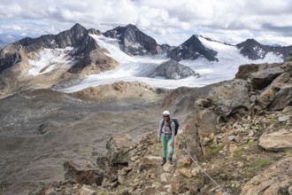 Mountaineer with helmet on a rope-insured path, in high mountain landscape, ascent to the Becher,