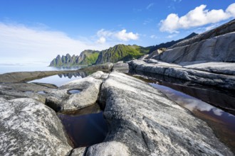 Reflection in a tidal pool, rocky coast of Tungeneset, Devil's Teeth, Okshornan, Ersfjorden, Senja