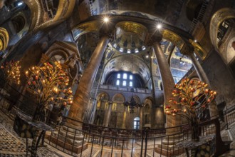 Wide angle view of the illuminated interior of saint mark's basilica in venice, italy, showcasing