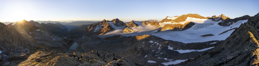 Picturesque high mountain landscape at sunrise with alpenglow, blue glacial lakes, glaciers and