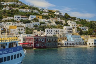 View from the water of a town with charming houses and hilly surroundings, Lakki, Leros,