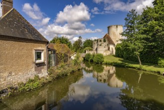 The river Loir and the castle with donjon in Alluyes, Centre-Val de Loire, France