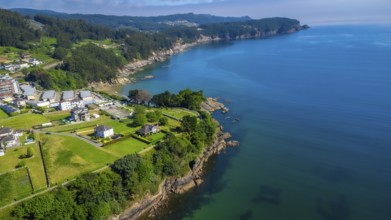 Breathtaking aerial view of covas beach meeting the cantabrian sea, showcasing the stunning