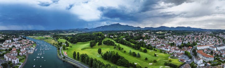 Panorama of Sunset and storm clouds over Pyrenees and Saint-Jean-de-Luz from a drone,