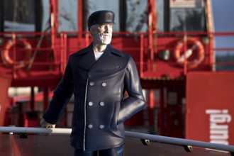 3-D figure of the captain permanently installed on the bow of the harbour ferry of line 62 in front