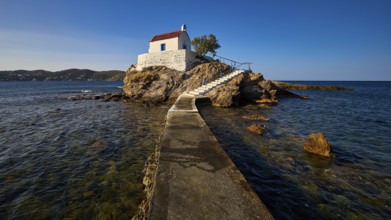 A pier leads to a white church on a rock, surrounded by the blue sea, chapel, church, Agios