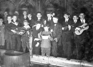 Boys in school uniform giving a performance, 1930s, Young men with guitars and mandolins, one