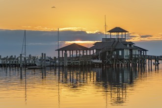 Biloxi Schooner Pier Complex at sunset on the Gulf of Mexico at Biloxi, Mississippi, USA