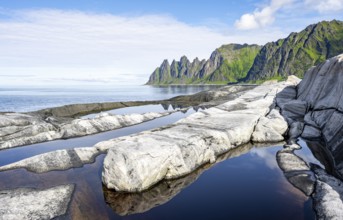 Reflection in a tidal pool, rocky coast of Tungeneset, Devil's Teeth, Okshornan, Ersfjorden, Senja