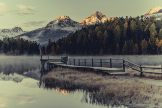 Lake Staz near Sankt Moritz in the Engadin in Switzerland. Morning atmosphere with fog in autumn.