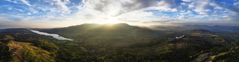 Panorama of Sunset over Mountains and Coniston Water from drone, Lake District National Park,