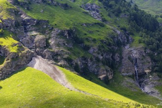 Waterfall and green slopes, Zinal valley, Val d'Anniviers, Valais Alps, Canton Valais, Switzerland