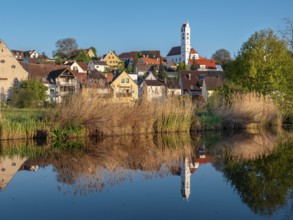 The old town centre with the Herz Jesu church is reflected in the River Wörnitz, Harburg,