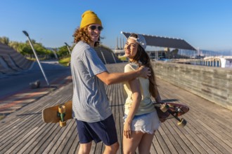 Smiling young adults skateboarding on a sunny boardwalk, capturing the essence of carefree summer