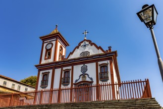 Facade of a colorful historic church in Baroque style in the old town of Diamantina in Minas