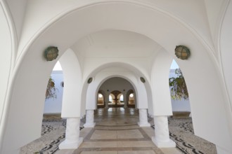 A bright corridor with white arches and decorative floor mosaic, Kalithea, Kallithea, thermal