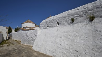 Church of Agia Kioura, White monastery wall under a blue sky, simple and traditional, Church,