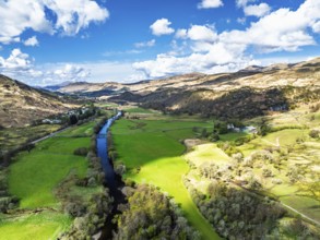 Farms and Mountains over River Dochart and Road A85 from a drone, Perthshire, Scotland, UK