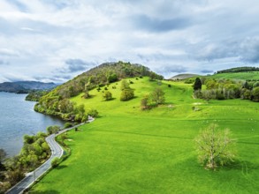 Farms and mountains over Ullswater Lake from drone, Pooley Bridge, Lake District National Park,
