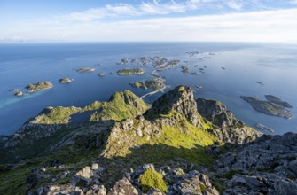 View of numerous small rocky islands with houses, at the summit of Festvågtind, view of