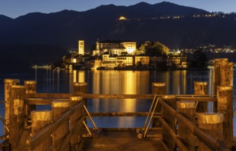 Wooden footbridge with view of Isola San Guilio, Orta San Giulio, on Lake Orta, Province of Novara,