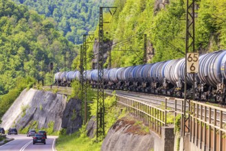 Goods train travelling on the winding Geislinger Steige railway line. Landscape along the railway