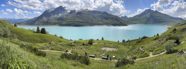 Panoramic view of Lac du Mont Cenis, in the foreground Alpine garden Jardin Alpin next to pass road